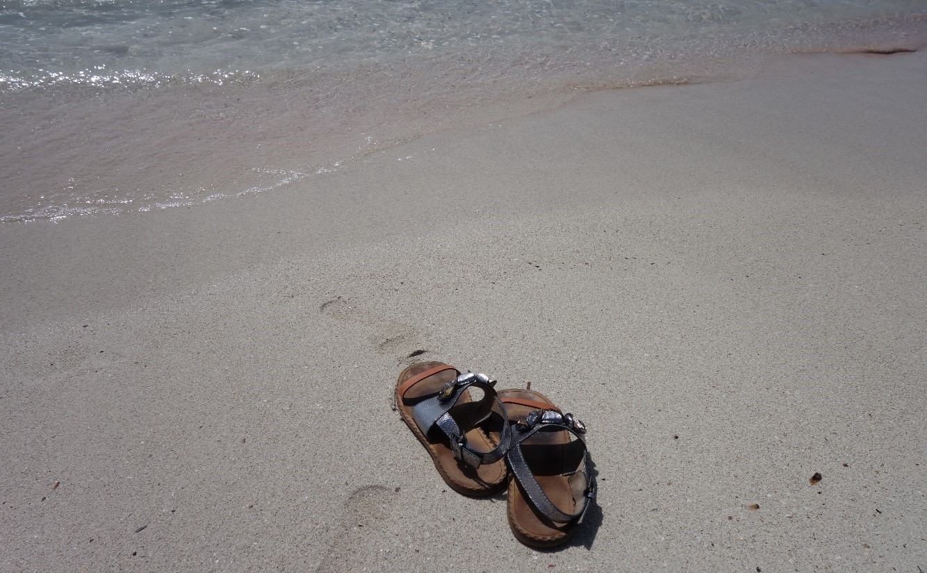 Sandals on beach in Menorca